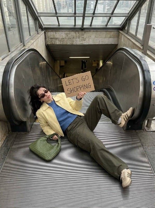 A young woman lying on an escalator, shot from a high overhead angle, wearing a …؛ محتوای مرتبط هوش مصنوعی در Axeto